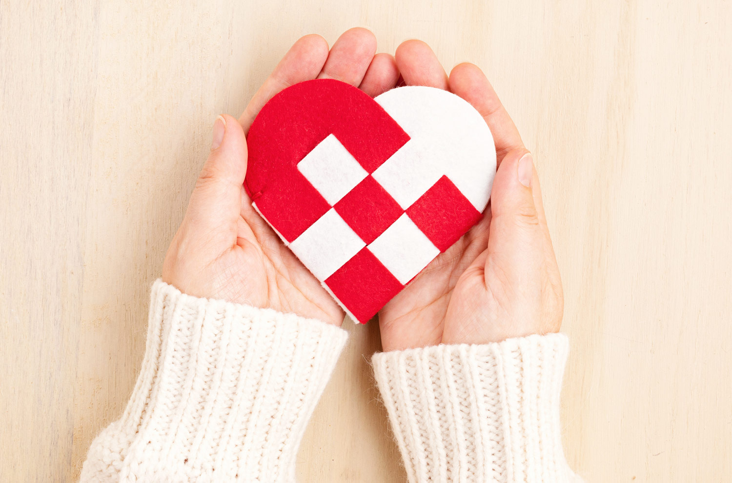 Giving Tuesday Hand holding paper heart